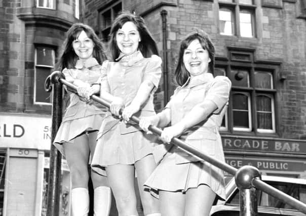 Triplets, from left, Evelyn, Elaine and Linda Wilson   aka The Karlins  at the top of Fleshmarket Close in Edinburgh