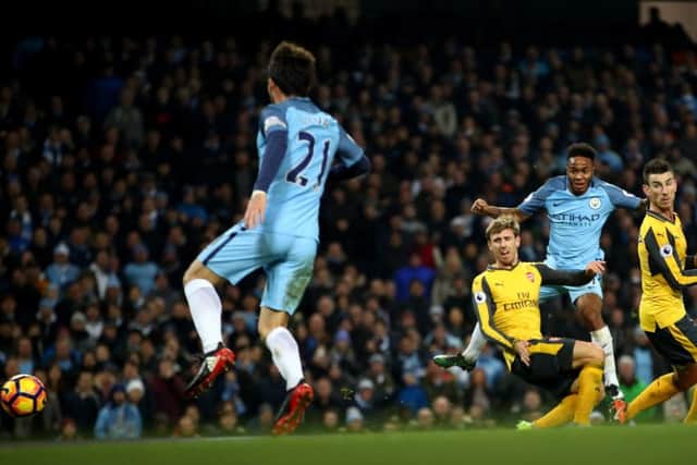 Theo Walcott finds the Manchester City net to give Arsenal the lead. Picture: Getty.