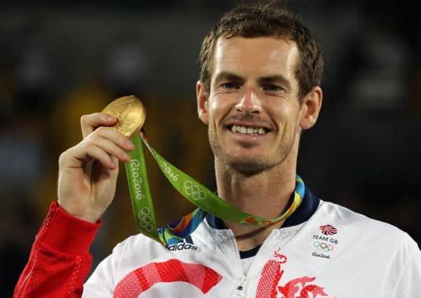 Andy Murray with his gold medal following victory in the men's singles final at the Olympic Tennis Centre. Picture: Owen Humphreys/PA Wire.