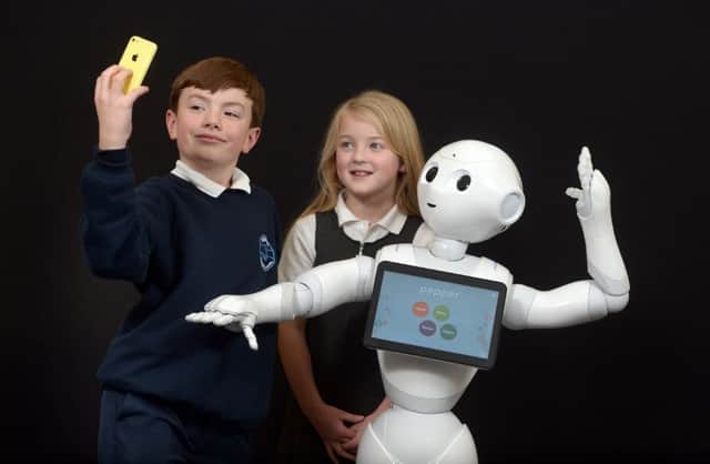 Chloe Porter and Joseph Mendonca are joined by Pepper, Heriot-Watt's resident robot. Picture: Contributed