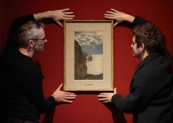 Michael Gormley (left) and Harris Brine from the Scottish National Gallery next to the Claude Monet pastel Etretal, L'aigulle et La Porte d'Aval. Picture: Andrew Milligan/PA Wire