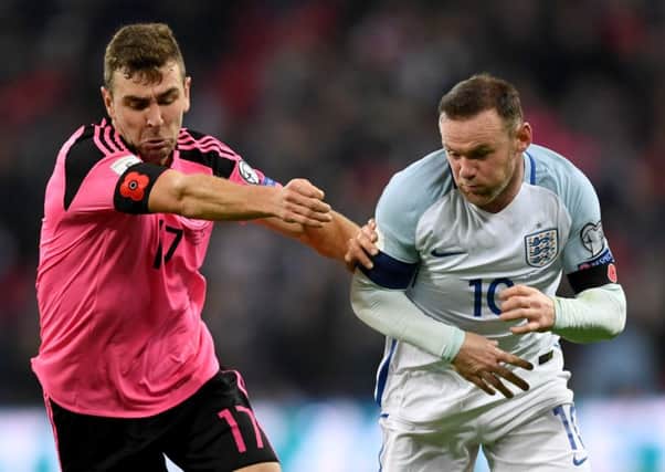 Scotland and England footballers defied a Fifa warning to wear poppy armbands on Armistice Day