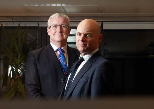 ASAM chief John Brett, left, with senior private wealth manager Shane Presley. Picture: Stewart Attwood