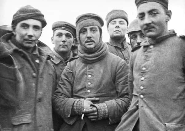 German and British soldiers stand together on the battlefield near Ploegsteert, Belgium in December 1914. Picture: AP