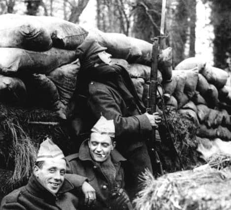 British soldiers in a trench on the Western Front in France wearing paper hats from Christmas crackers. Picture: PA