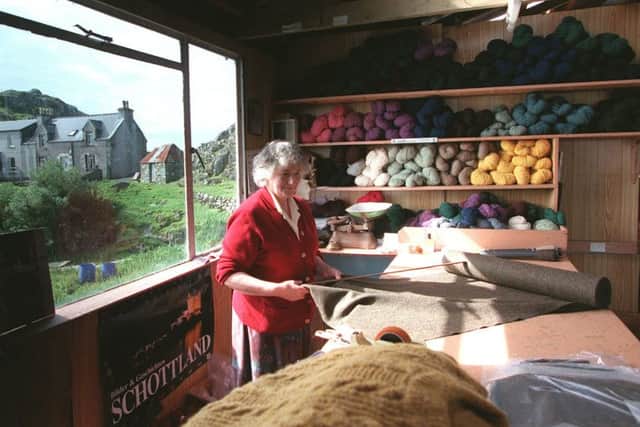 Katie Campbell measures a length of Harris tweed from a bort after weaving at Plockropool, on the east side of the island, in 1998. Picture: Allan Milligan/TSPL