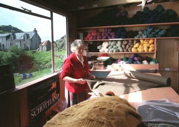 Katie Campbell measures a length of Harris tweed from a bort after weaving at Plockropool, on the east side of the island. Picture: Allan Milligan/TSPL