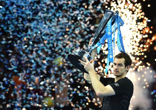 Andy Murray raises the trophy after defeating Novak Djokovic ro win the World Tour Finals. Picture: AFP/Getty.