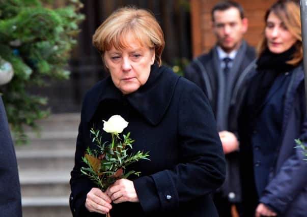 German chancellor Angela Merkel  arrives at a Christmas market in Berlin the day after a truck was driven into the crowd killing  12  people. Picture AP