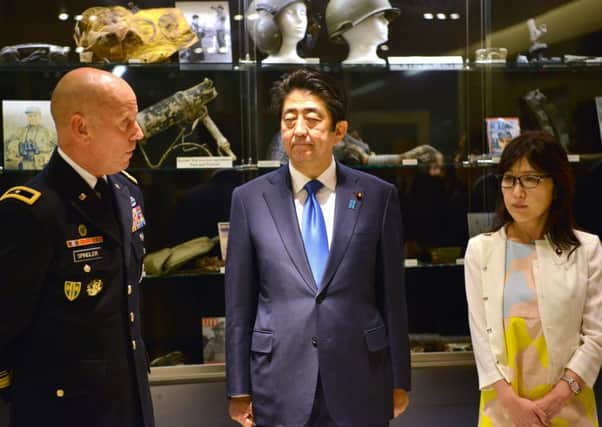 Prime Minister Shinzo Abe, centre, on his Pearl Harbor visit. Picture: AFP/Getty Images