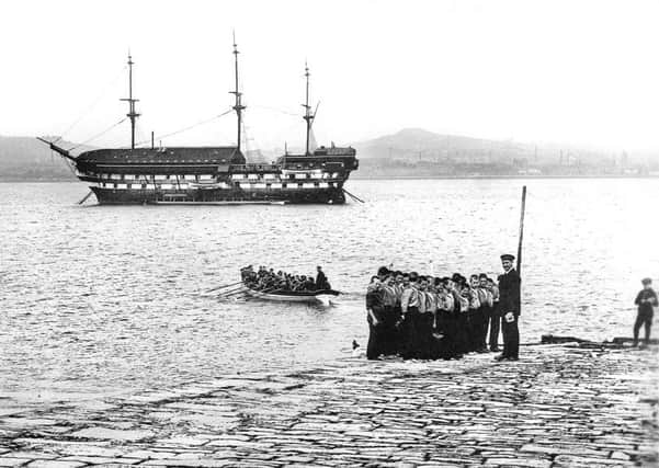 The Mars Training Ship for Homeless and Destitute Boys anchored in the River Tay with some of its young residents pictured in the foreground. PIC Contributed/The History Press.