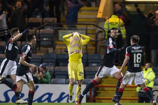 Dundees Canadian striker Marcus Haber runs away to celebrate his winner while Hearts Liam Smith hides his face in frustration. Picture: Kenny Smith/SNS