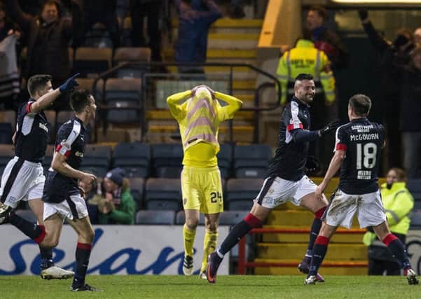 Dundees Canadian striker Marcus Haber runs away to celebrate his winner while Hearts Liam Smith hides his face in frustration. Picture: Kenny Smith/SNS