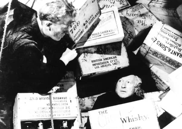 Gordon Jackson, left, in a scene from the 1949 film Whisky Galore. Picture: Mirror Syndication International