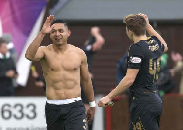 Celtic's Emilio Izaguirre (left) and James Forrest celebrate after the final whistle of the match at New Douglas Park, Hamilton. Picture: Jeff Holmes/PA Wire