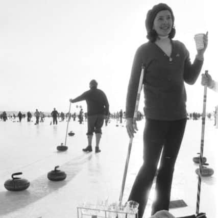 A woman stops for a drink during the grand match of the Royal Caledonian Curling Club on the Lake of Menteith in Perthshire, February 1979. PIC Ian Brand/TSPL.