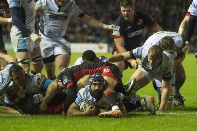 Glasgow's Josh Strauss, centre, looks up after diving over the line for his side's second try in their 25-12 1872 Cup first-leg win over Edinburgh. Picture: Bill Murray/SNS