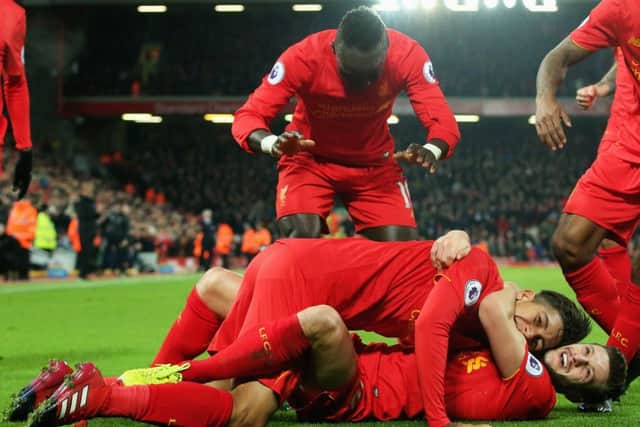 Roberto Firmino of Liverpool celebrates with Adam Lallana during the win over Stoke at Anfield. Picture: Alex Livesey/Getty Images