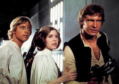 Carrie Fisher as Princess Leia Organa with Harrison Ford and Mark Hamill. Picture: AP