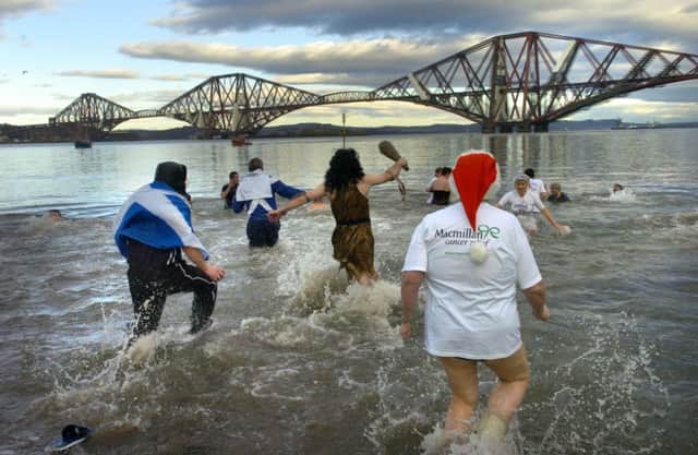 The Loony Dook: Revellers brave freezing temperatures by bathing in the firth of the forth every New Year's Day. Picture: Julie Howden