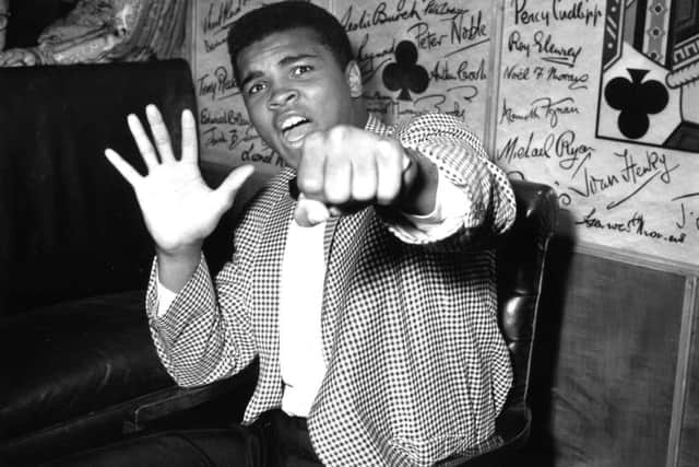 Muhammad Ali, then known as Cassius Clay, holds up five fingers in a prediction of how many rounds it will take him to knock out Henry Cooper in 1963.  Picture: Kent Gavin/Keystone/Getty Images