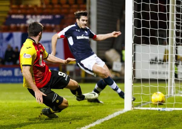 Kris Doolan, left, puts Partick Thistle two goals to the good. Picture: SNS