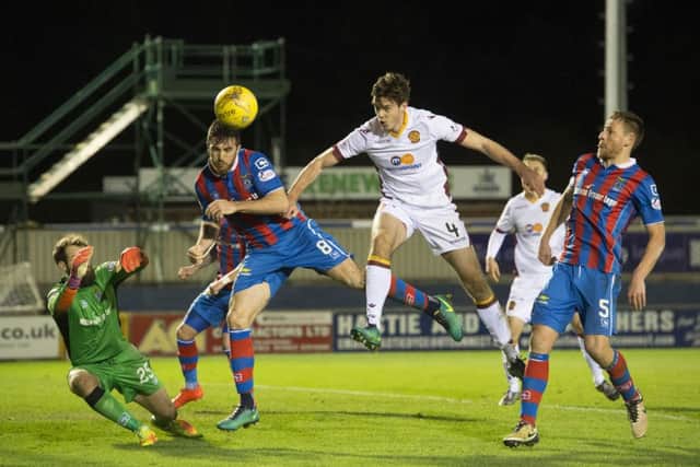 Ross Draper battles for the ball against Motherwell's Ben Heneghan (right). Picture: SNS