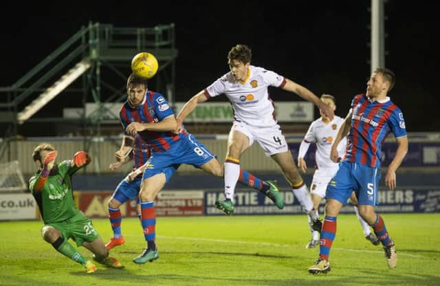 Ross Draper battles for the ball against Motherwell's Ben Heneghan (right). Picture: SNS