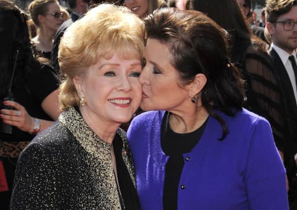 Debbie Reynolds, left, and Carrie Fisher at the Primetime Creative Arts Emmy Awards in Los Angeles.  Reynolds famously starred in the 1952 classic "Singin' in the Rain" Picture; AP.
