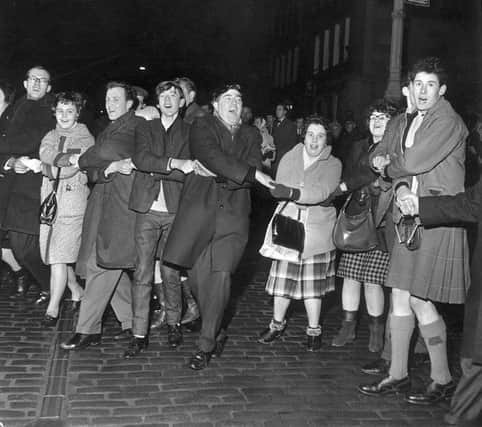 People singing Auld Lang's Syne during New Year at the Tron in 1964. Picture: TSPL