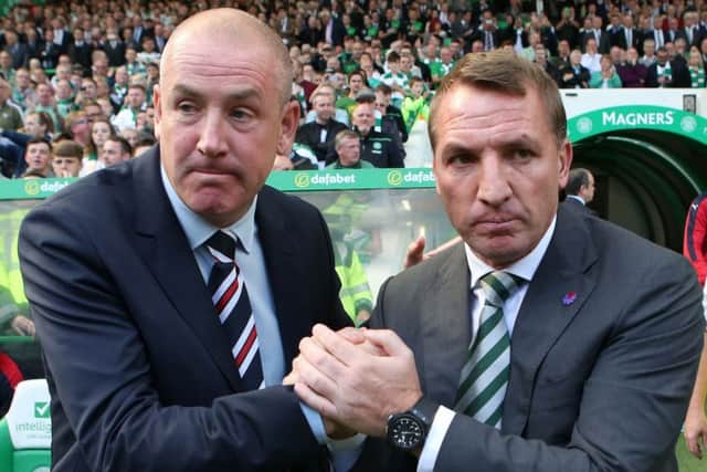 Mark Warburton, left, will go head to head with Brendan Rodgers once again this weekend. Picture: PA