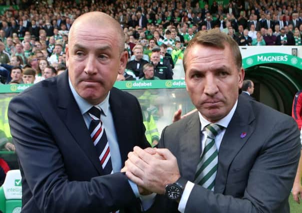 Mark Warburton, left, will go head to head with Brendan Rodgers once again this weekend. Picture: PA