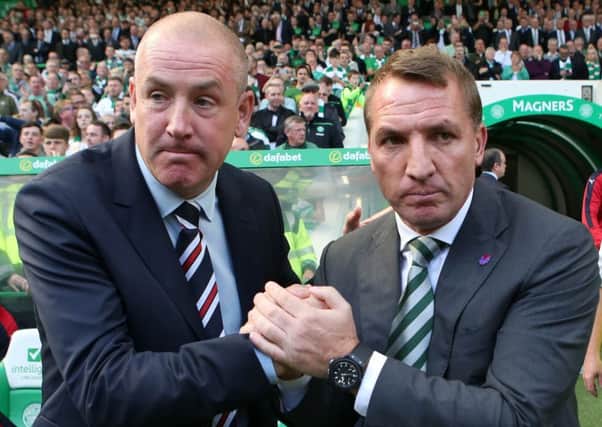 Rangers boss Mark Warburton, left, hopes to end Celtic manager Brendan Rodgers' unbeaten run on Hogmanay. Picture: Andrew Milligan/PA