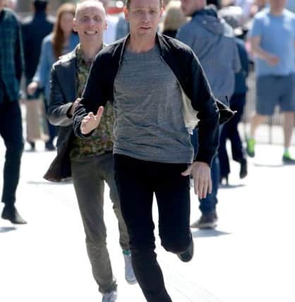 Actors Ewan McGregor (front) and Ewan Bremner (behind) running through the streets of Edinburgh . Picture: PA