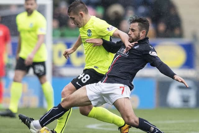 Falkirks Tom Taiwo challenges Scott Martin of Hibs during Saturdays clash. Picture: SNS