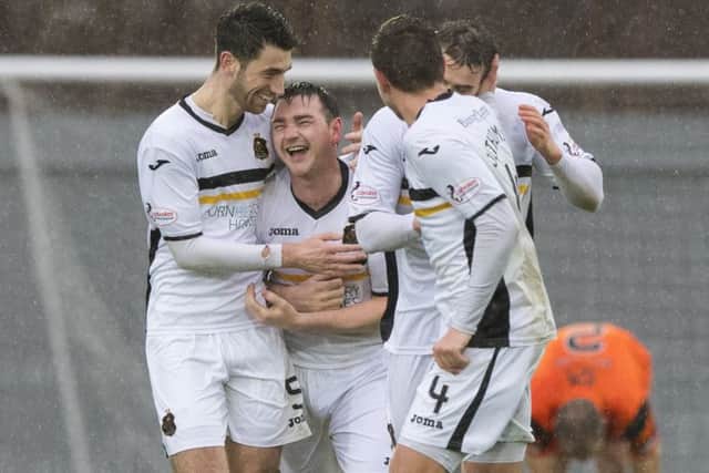 Dumbartons Mark Docherty celebrates after his wind-assisted cross looped into the net. Photograph: Gary Hutchison/SNS