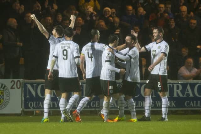 St Mirren's Gary MacKenzie, left, celebrates scoring the opening goal. Picture: SNS