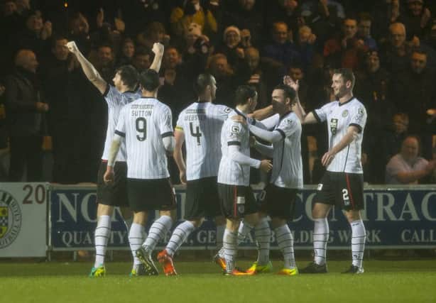 St Mirren's Gary MacKenzie, left, celebrates scoring the opening goal. Picture: SNS