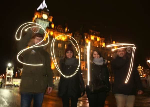People light write 2017 in Princes Street prior to the Hogmanay New Year celebrations in Edinburgh. Picture: PA