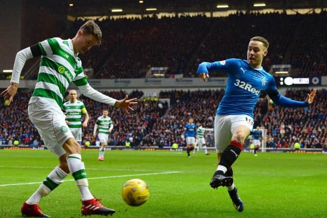 Rangers' Barrie McKay tries to block a clearance by Celtic's Mikael Lustig. Picture: Mark Runnacles/Getty Images