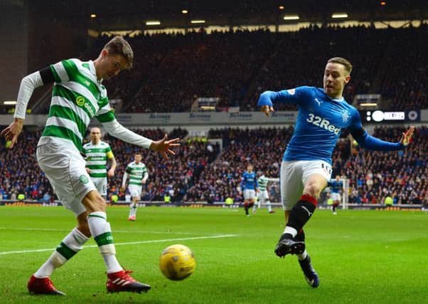 Rangers' Barrie McKay tries to block a clearance by Celtic's Mikael Lustig. Picture: Mark Runnacles/Getty Images