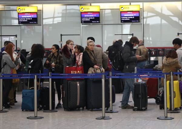 Passengers queue at Heathrow airport. Picture: SWNS