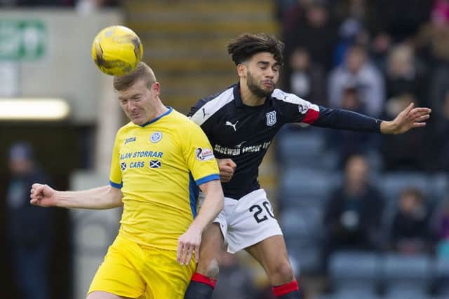 St Johnstones Brian Easton, left, and Faissal El Bakhtaoui of Dundee engage in an aerial duel. Picture: SNS.