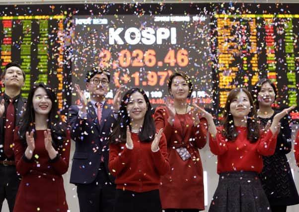 Share prices have greeted the New Year in a champagne mood, writes Bill Jamieson. Picture: Ahn Young-joon/AP