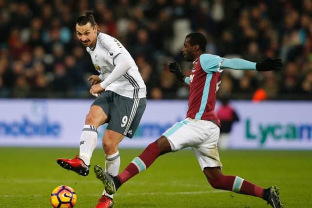 Zlatan Ibrahimovic, left, slots home Manchester Uniteds second goal to seal victory against West Hamt. Picture: AFP/Getty.
