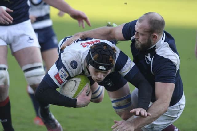 Martin Hughes of Heriot's is tackled by Rory Drummond of the Co-Optimists at
Goldenacre.
Picture: Neil Hanna