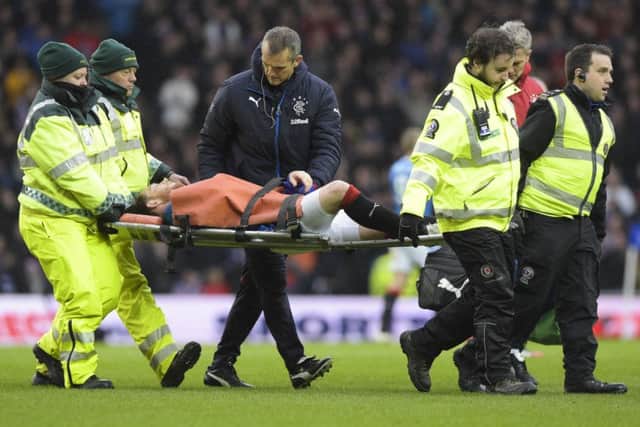 Joe Garner is stretchered off durong Saturday's Old Firm game. Picture: SNS