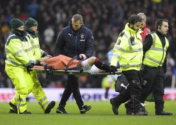 Joe Garner is stretchered off durong Saturday's Old Firm game. Picture: SNS