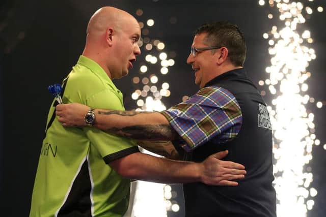 Michael van Gerwen, left, celebrates winning the William Hill World Darts Championship final against Gary Anderson at Alexandra Palace, London. Picture: Steven Paston/PA Wire