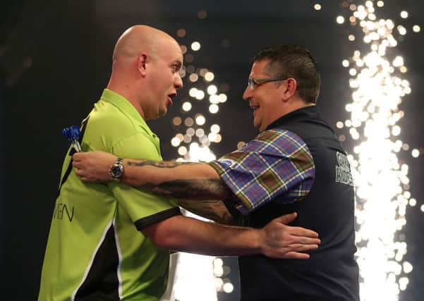 Michael van Gerwen, left, celebrates winning the William Hill World Darts Championship final against Gary Anderson at Alexandra Palace, London. Picture: Steven Paston/PA Wire